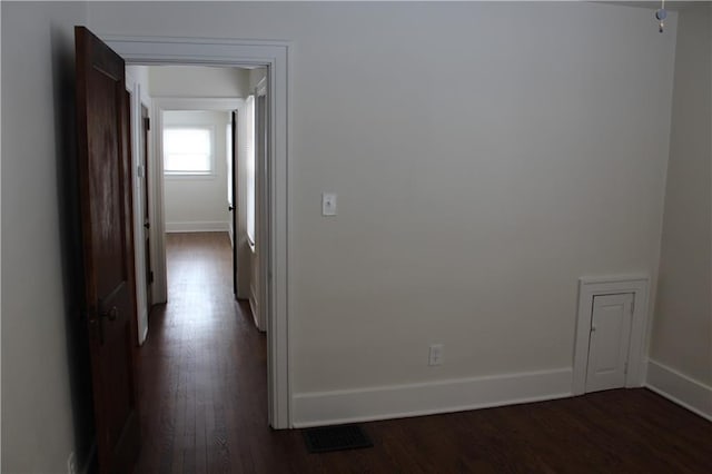 hall with dark wood-type flooring