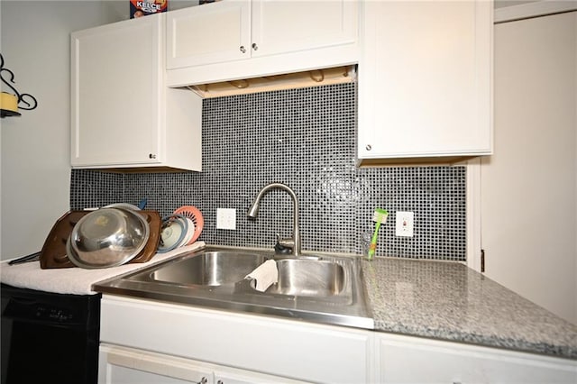 kitchen featuring dishwasher, white cabinetry, and sink