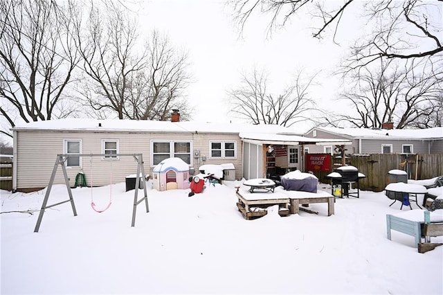 view of snow covered rear of property