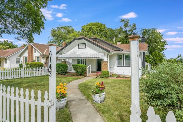 bungalow-style home featuring a front yard