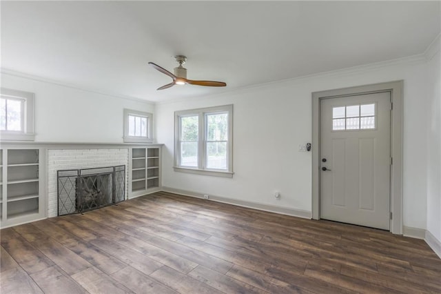 unfurnished living room featuring a fireplace, plenty of natural light, and crown molding