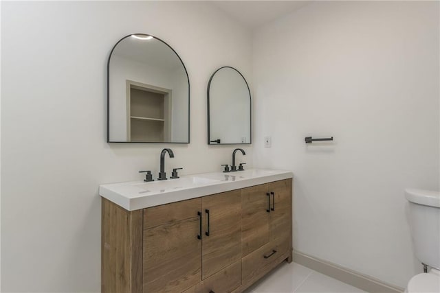 bathroom featuring tile patterned floors, vanity, and toilet