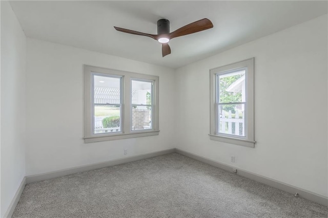 empty room featuring carpet flooring and ceiling fan