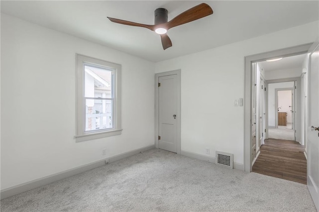 unfurnished bedroom featuring carpet and ceiling fan