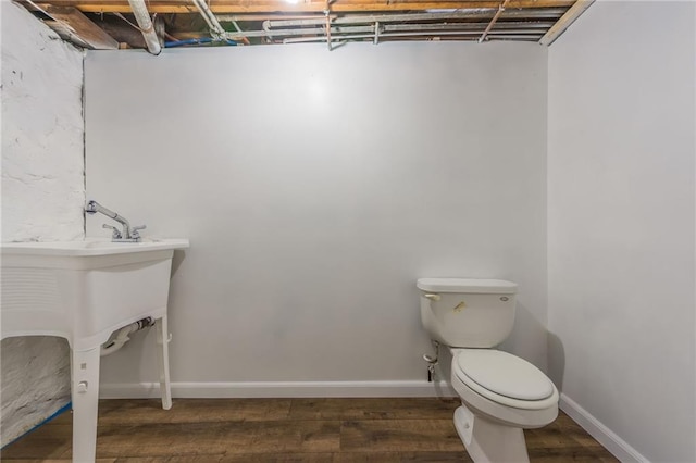 bathroom with hardwood / wood-style floors and toilet