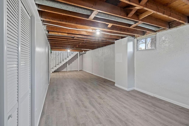 basement with hardwood / wood-style flooring