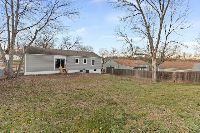 back of house featuring a yard