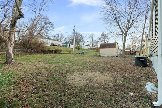 view of yard featuring a shed and central air condition unit