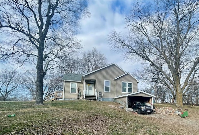 view of front facade with a front yard and a carport