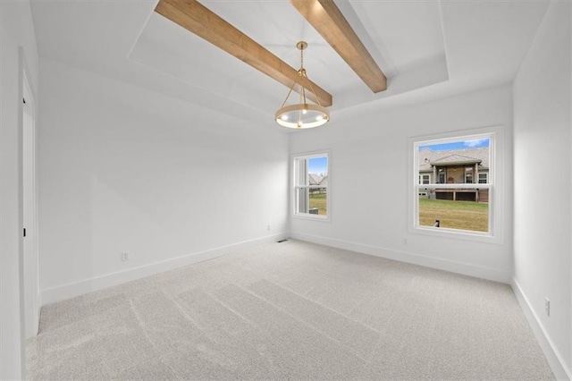 carpeted empty room with beamed ceiling