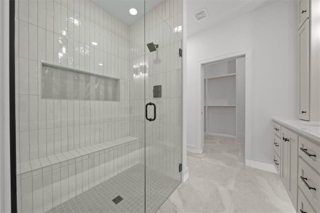 bathroom featuring vanity and an enclosed shower