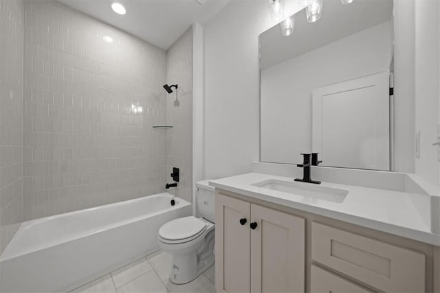 full bathroom featuring vanity, tile patterned floors, toilet, and tiled shower / bath