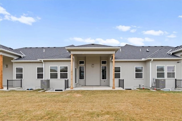 rear view of property featuring a yard, central AC unit, and a patio area