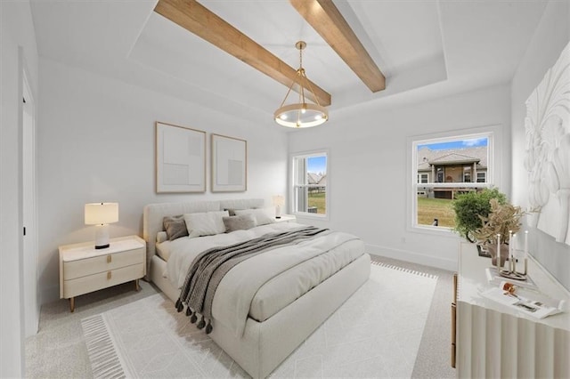 carpeted bedroom with beam ceiling