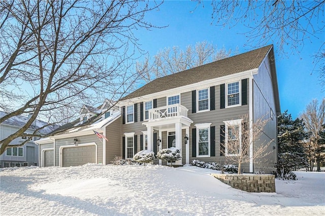 colonial house with a balcony and a garage