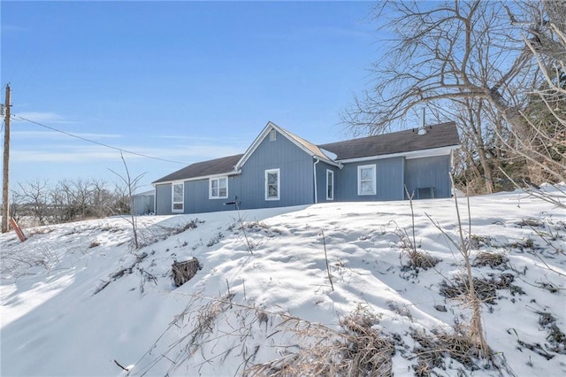 view of snow covered back of property