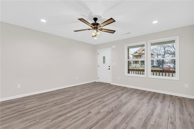 spare room with ceiling fan and light hardwood / wood-style floors