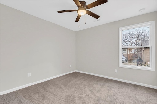 carpeted empty room featuring ceiling fan