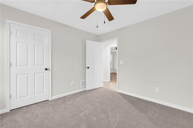 unfurnished bedroom with ceiling fan and light carpet