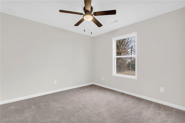 carpeted spare room featuring ceiling fan