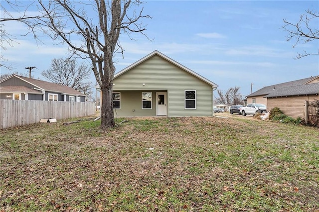 rear view of property with a lawn