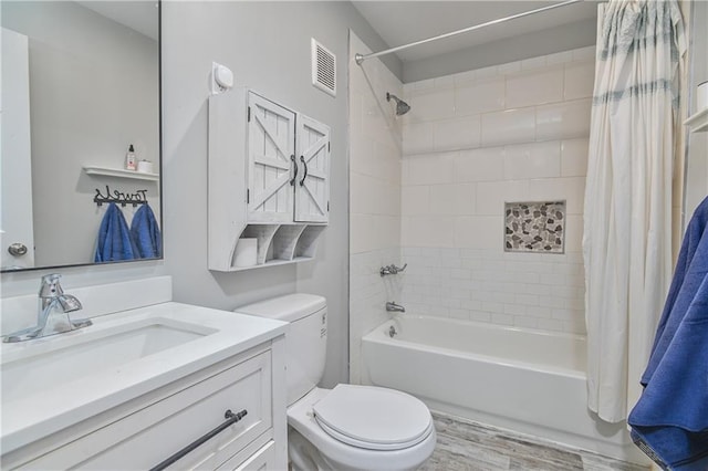 full bathroom with vanity, hardwood / wood-style flooring, toilet, and shower / bathtub combination with curtain