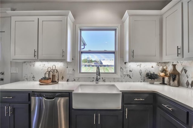 kitchen featuring dishwasher, decorative backsplash, white cabinetry, and sink