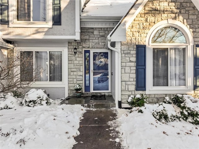 view of snow covered property entrance