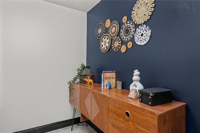 room details with a textured ceiling and baseboards