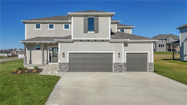 view of front of house featuring a garage and a front lawn