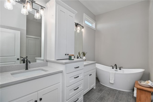 bathroom with a tub and vanity