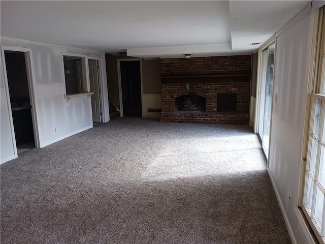 unfurnished living room featuring carpet flooring and a fireplace