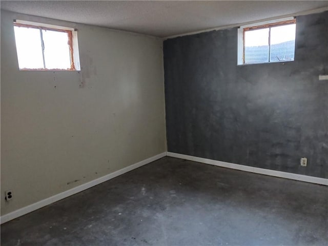 basement with plenty of natural light and a textured ceiling