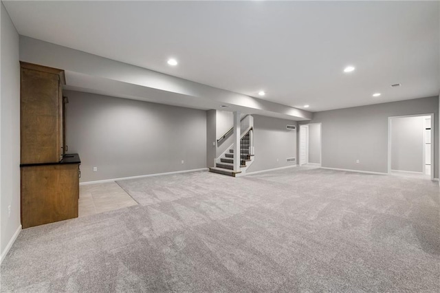 basement featuring light carpet