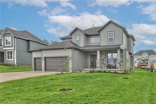 view of front of home featuring a garage, a front lawn, and covered porch