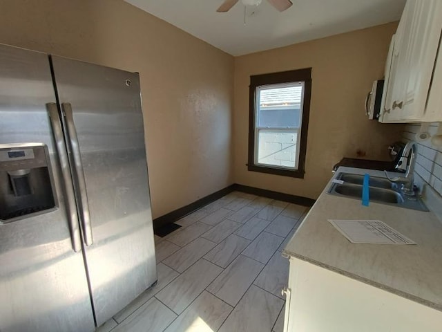 kitchen with white cabinetry, sink, ceiling fan, and stainless steel refrigerator with ice dispenser