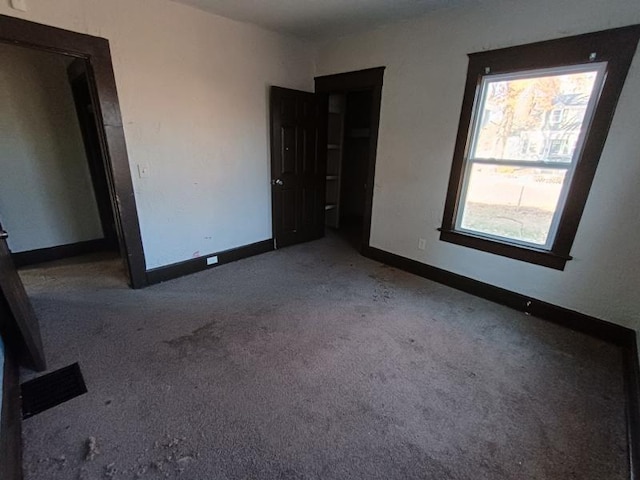 carpeted empty room with plenty of natural light