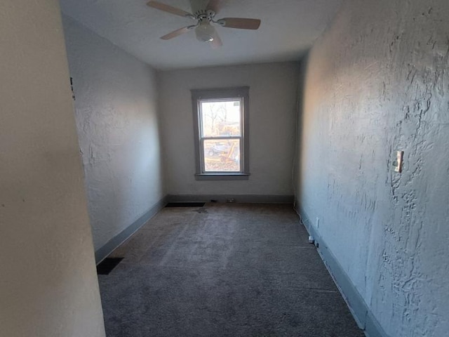 carpeted spare room with ceiling fan