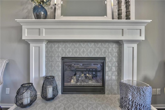 interior details featuring a tiled fireplace