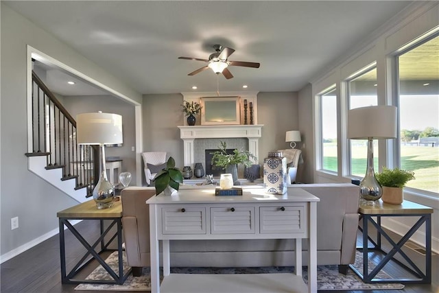 living room featuring dark hardwood / wood-style flooring and ceiling fan