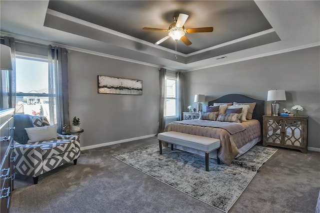 carpeted bedroom with a raised ceiling, ceiling fan, and crown molding