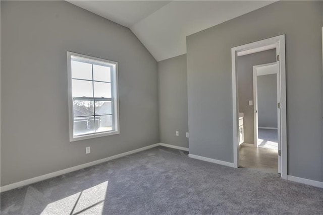 empty room featuring carpet floors and lofted ceiling