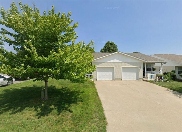 view of front of home featuring a porch, a front lawn, and a garage