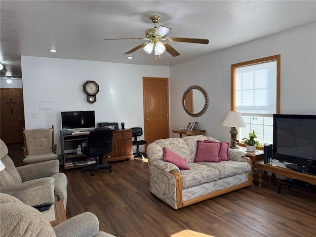 living room with ceiling fan and dark hardwood / wood-style flooring