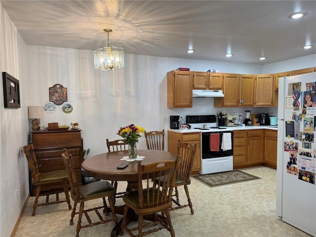 kitchen with white appliances, a chandelier, and pendant lighting