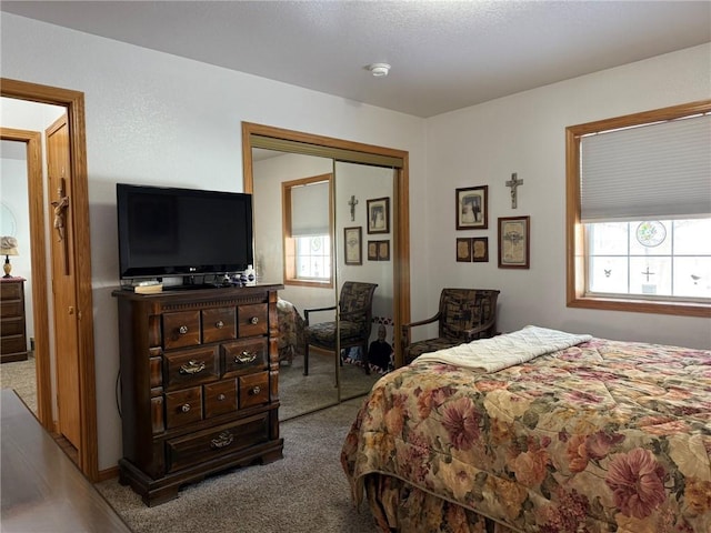 carpeted bedroom with a closet