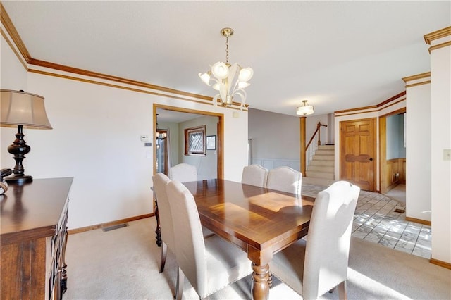 dining space with stairs, visible vents, crown molding, and light colored carpet