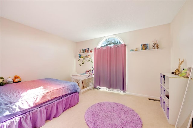 bedroom featuring light carpet