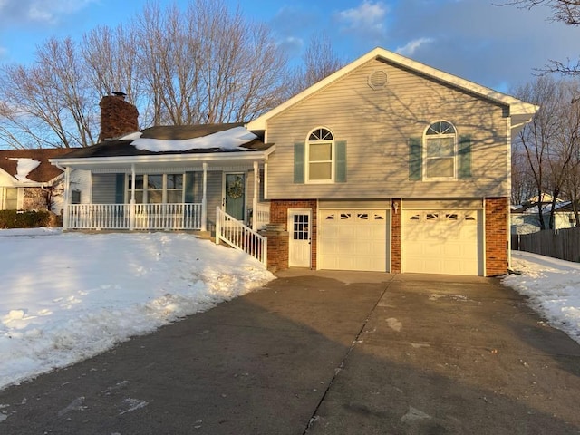 split level home with a garage and covered porch