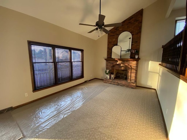 unfurnished living room featuring ceiling fan, a large fireplace, light colored carpet, and high vaulted ceiling